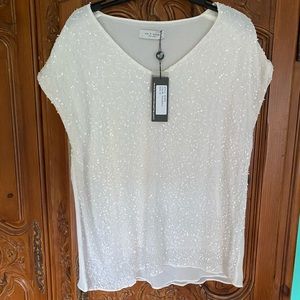 Crepe eggshell white with pretty little sparklers sewn in.